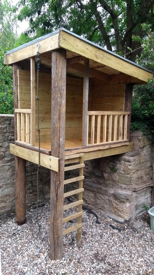 Stilted treehouse against a wall