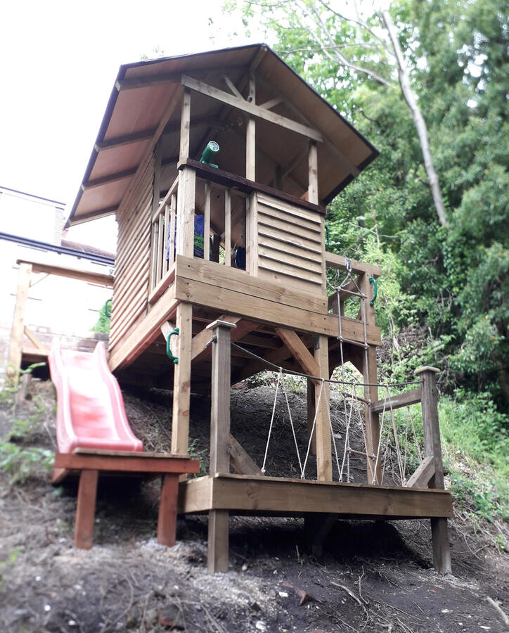 The upper and lower treehouse decks with slide