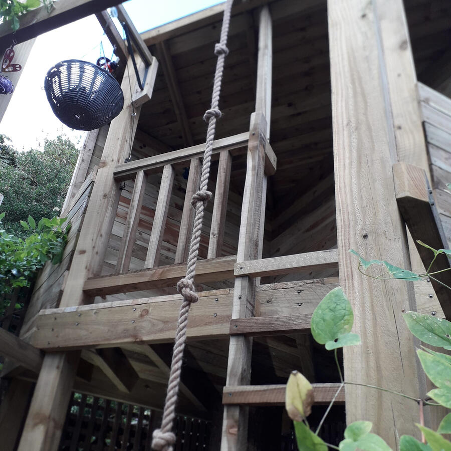 Kids have a choice of climbing rope or ladder to get in